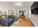 Open-concept living space with hardwood floors, leading to the dining and kitchen areas at 211 Hargrove St St, Durham, NC 27701