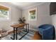 Office featuring a wood desk, comfortable seating, and natural light from two windows at 211 Hargrove St St, Durham, NC 27701
