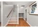 Stairway features hardwood treads, painted risers, stained handrail, and hardwood floors at 211 Hargrove St St, Durham, NC 27701