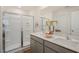 Modern bathroom with a double sink vanity, glass shower, and ample lighting at 214 Oak Barrel St, Smithfield, NC 27577