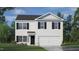 Charming two-story home featuring a classic white facade, black shutters, and an attached two-car garage at 214 Oak Barrel St, Smithfield, NC 27577