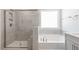 Modern bathroom showcasing a tiled shower with glass door and a separate soaking tub at 2322 Sugar Cone Way, Fuquay Varina, NC 27526