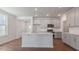 Open kitchen featuring gray cabinets, stainless steel appliances, and a large center island at 2322 Sugar Cone Way, Fuquay Varina, NC 27526