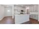 Modern kitchen featuring gray cabinets, stainless steel appliances, and a large center island at 2322 Sugar Cone Way, Fuquay Varina, NC 27526