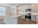 Stylish kitchen featuring gray cabinets, stainless steel appliances, subway tile, and a center island at 2322 Sugar Cone Way, Fuquay Varina, NC 27526