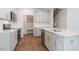 Well-equipped kitchen featuring gray cabinets, stainless steel appliances, and a view of the staircase at 2322 Sugar Cone Way, Fuquay Varina, NC 27526