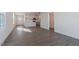 Open living area featuring gray wood-look floors and an open layout with a kitchen view at 2322 Sugar Cone Way, Fuquay Varina, NC 27526