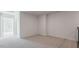 A versatile living room space with neutral carpeting and a glimpse into an adjacent room at 2322 Sugar Cone Way, Fuquay Varina, NC 27526