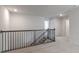 Second-floor loft area with dark wooden bannister and stairway at 2322 Sugar Cone Way, Fuquay Varina, NC 27526