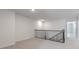 Second-floor loft with new carpet, featuring a dark wooden bannister and stairway at 2322 Sugar Cone Way, Fuquay Varina, NC 27526