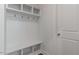 Convenient mudroom featuring built-in shelving, coat hooks, and a bench at 2322 Sugar Cone Way, Fuquay Varina, NC 27526
