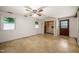 Spacious bedroom with two windows, an exterior door, carpet floors and a ceiling fan at 2417 Lawrence Dr, Raleigh, NC 27603