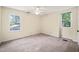 Simple bedroom with neutral carpet and two windows offering natural light at 2417 Lawrence Dr, Raleigh, NC 27603