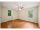 Bedroom with hardwood floors and two windows at 2417 Lawrence Dr, Raleigh, NC 27603