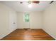 This bedroom has hardwood floors, neutral walls, and a ceiling fan with a light fixture at 2417 Lawrence Dr, Raleigh, NC 27603