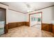 Open dining room with wood trim, neutral walls, linoleum floors, and view into a sun filled dining area at 2417 Lawrence Dr, Raleigh, NC 27603