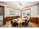 Staged dining room with table set for four and view to bright connecting living area at 2417 Lawrence Dr, Raleigh, NC 27603