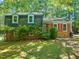 Charming two-story home with a brick facade and lush green landscaping at 2417 Lawrence Dr, Raleigh, NC 27603