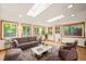 Bright living room featuring many windows, skylights, modern furniture and wood flooring at 2417 Lawrence Dr, Raleigh, NC 27603