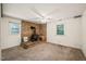 Living room featuring a wood-burning stove, carpet, and natural light from the two windows at 2417 Lawrence Dr, Raleigh, NC 27603