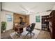Home office featuring a wood-burning stove, built-in bookshelves, and natural light at 2417 Lawrence Dr, Raleigh, NC 27603