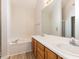 Bathroom features a soaking tub and double sink vanity with wood cabinets, offering a spa-like experience at 2424 Horizon Hike Ct, Raleigh, NC 27603