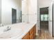 Bathroom featuring a double sink vanity with wood cabinets, with an open view to a bedroom area at 2424 Horizon Hike Ct, Raleigh, NC 27603