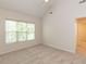 Bright bedroom features neutral walls, carpeting, and a large window, creating a cozy and inviting atmosphere at 2424 Horizon Hike Ct, Raleigh, NC 27603