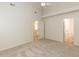 A bright bedroom features neutral walls, carpeting, and two open doors, creating an inviting atmosphere at 2424 Horizon Hike Ct, Raleigh, NC 27603