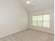 Bedroom with neutral carpeting, ceiling fan and a large window at 2424 Horizon Hike Ct, Raleigh, NC 27603