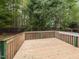 Wooden deck offering a relaxing outdoor space, surrounded by trees and greenery at 2424 Horizon Hike Ct, Raleigh, NC 27603