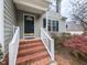 Close up of home's entrance showcasing brick steps and white railings with landscaping including a Japanese maple at 2424 Horizon Hike Ct, Raleigh, NC 27603