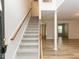 Entryway with carpeted stairs leading to the upper level, light wood floors, and views into other rooms at 2424 Horizon Hike Ct, Raleigh, NC 27603