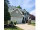 Two-story home featuring an attached garage, a well-maintained lawn, and traditional architecture with gray siding at 2424 Horizon Hike Ct, Raleigh, NC 27603