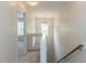 Upstairs hallway features a window and a view to a bedroom and the staircase at 2424 Horizon Hike Ct, Raleigh, NC 27603
