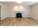 Spacious living room with wood-look floors, white walls, and a fireplace with an elegant white mantel at 2424 Horizon Hike Ct, Raleigh, NC 27603