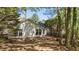 Back of a one-story home with a brick patio surrounded by mature trees at 2941 Golden Oak Ct Ct, Raleigh, NC 27603