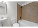 Clean bathroom featuring a bathtub-shower combo, a white toilet, and a basin sink at 2941 Golden Oak Ct Ct, Raleigh, NC 27603