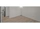 Bright, minimalist bedroom featuring wood floors, white walls, and open doorway at 2941 Golden Oak Ct Ct, Raleigh, NC 27603