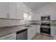 Kitchen showcasing granite counters, white cabinets, and stainless steel appliances at 2941 Golden Oak Ct Ct, Raleigh, NC 27603