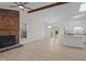 Bright living room features a brick fireplace, high ceilings, wood beam, skylight, and kitchen with granite countertops at 2941 Golden Oak Ct Ct, Raleigh, NC 27603