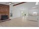 Bright living room with ceiling fan, brick fireplace and new floors, seamlessly integrates with the kitchen at 2941 Golden Oak Ct Ct, Raleigh, NC 27603