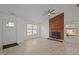 Bright living room featuring a brick fireplace, ceiling fan, new floors and large windows at 2941 Golden Oak Ct Ct, Raleigh, NC 27603