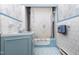 Classic bathroom features a blue vanity, matching tiled floors, and a shower-tub combination at 305 N Ellis Ave, Dunn, NC 28334