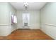 This bedroom with hardwood flooring has a large window and neutral walls, ready for personalization at 305 N Ellis Ave, Dunn, NC 28334