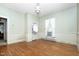 This bedroom features hardwood floors, a vintage light fixture, and wallpaper in an antique style at 305 N Ellis Ave, Dunn, NC 28334
