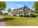 Charming two-story home with black shutters, landscaped yard, and inviting front entrance at 305 N Ellis Ave, Dunn, NC 28334