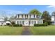 Charming two-story home with black shutters, landscaped yard, and inviting front entrance at 305 N Ellis Ave, Dunn, NC 28334