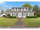 Charming two-story home with black shutters, landscaped yard, and inviting front entrance at 305 N Ellis Ave, Dunn, NC 28334