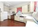 Retro kitchen with brick floor, vintage appliances, bright cabinets, and eat-in breakfast nook at 305 N Ellis Ave, Dunn, NC 28334
